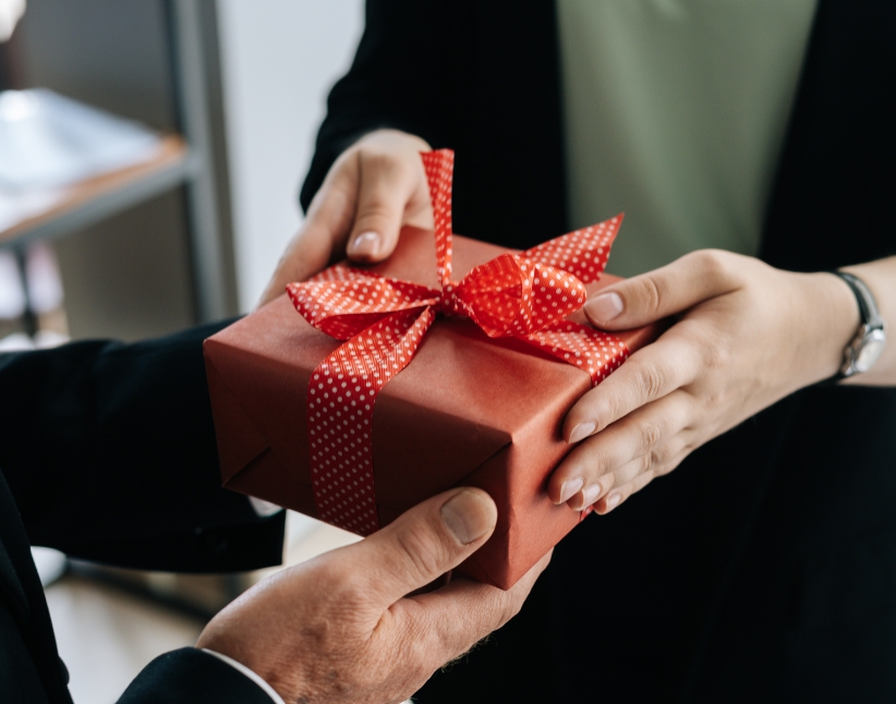 Someone giving someone a gift.